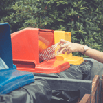 Woman-Drop-Plastic-Bottle-Into-bin